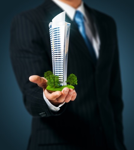 Man holding a skyscraper in hand